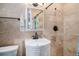 Bathroom with modern fixtures, a white vanity, neutral tile, and a shower at 1004 W Shepperd Ave, Littleton, CO 80120