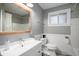 Bright, clean bathroom with a white vanity, gray walls and a tile shower-tub combo at 1004 W Shepperd Ave, Littleton, CO 80120