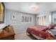 Cozy bedroom with neutral colors, plush carpet, and a large window letting in natural light at 1004 W Shepperd Ave, Littleton, CO 80120