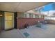 Brick home featuring a covered carport with an adjacent cozy outdoor sitting area at 1004 W Shepperd Ave, Littleton, CO 80120