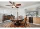 Dining room with hardwood floors, a round table with chairs, and a vintage cabinet with glass doors at 1004 W Shepperd Ave, Littleton, CO 80120