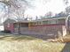 Inviting single-story home with brick and wood accents, a well-kept lawn, and mature trees at 1004 W Shepperd Ave, Littleton, CO 80120