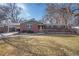 Charming brick home with manicured lawn, complemented by a covered carport, and inviting front porch at 1004 W Shepperd Ave, Littleton, CO 80120