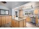 Open kitchen featuring granite countertops, stainless steel appliances, and wood cabinets at 1004 W Shepperd Ave, Littleton, CO 80120