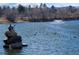 Picturesque lake scene with a statue and lush surroundings at 1004 W Shepperd Ave, Littleton, CO 80120