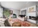 Bright living room with a cozy fireplace, red area rug, and decorative accents at 1004 W Shepperd Ave, Littleton, CO 80120