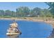 View of Ketring Pond with the statue of the fisherman and a view of the mature trees at 1004 W Shepperd Ave, Littleton, CO 80120