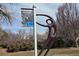 Outside view of a running sculpture with a sign displaying the name Chuck Brenton at 1004 W Shepperd Ave, Littleton, CO 80120