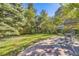 Large backyard with grass, trees, and a stone patio at 350 Cherry St, Denver, CO 80220