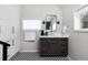 Modern bathroom with dark vanity, patterned floor, and updated fixtures at 350 Cherry St, Denver, CO 80220