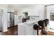 Modern kitchen with white cabinets, stainless steel appliances, and a breakfast bar at 350 Cherry St, Denver, CO 80220