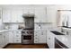 Modern kitchen with white cabinets, stainless steel appliances and gas range at 350 Cherry St, Denver, CO 80220