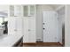 White kitchen cabinets and pantry with glass doors at 350 Cherry St, Denver, CO 80220