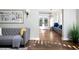 Living room with hardwood floors, gray sofa, and view to the dining area at 350 Cherry St, Denver, CO 80220