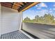 Cozy balcony with wood-style flooring, white siding, and a view of green trees and a blue sky at 485 Interlocken Blvd # 202, Broomfield, CO 80021