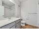 Bathroom featuring a single sink vanity, toilet, and shower with wood-style floor at 485 Interlocken Blvd # 202, Broomfield, CO 80021