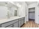 Modern bathroom with a double sink vanity, quartz countertops, and a glass-enclosed shower at 485 Interlocken Blvd # 202, Broomfield, CO 80021