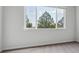 Bright bedroom with gray carpet and a large window providing scenic views at 485 Interlocken Blvd # 202, Broomfield, CO 80021