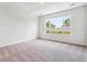 Bright bedroom featuring plush carpet, white walls, and a large window with scenic outdoor views at 485 Interlocken Blvd # 202, Broomfield, CO 80021