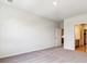 Spacious bedroom with neutral carpet, white walls, and access to an en-suite bathroom and closet at 485 Interlocken Blvd # 202, Broomfield, CO 80021