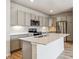 Kitchen featuring an island with a sink and gray cabinets with quartz countertops at 485 Interlocken Blvd # 202, Broomfield, CO 80021