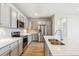 Modern kitchen with stainless steel appliances, light gray cabinets, and quartz countertops at 485 Interlocken Blvd # 202, Broomfield, CO 80021