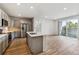 Open-concept kitchen and living area with stainless steel appliances and modern finishes at 485 Interlocken Blvd # 202, Broomfield, CO 80021