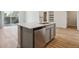 Kitchen island with stainless steel dishwasher, sink, and quartz countertop at 485 Interlocken Blvd # 202, Broomfield, CO 80021