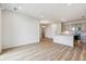 Open concept living space with wood flooring, a kitchen island and stainless steel appliances at 485 Interlocken Blvd # 202, Broomfield, CO 80021