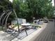 Enjoy this deck and outdoor living space with patio furniture and a swing set at 12931 W Florida Dr, Lakewood, CO 80228