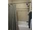 Clean bathroom showcasing a bathtub with tile surround, shower curtain, and convenient storage shelves at 12931 W Florida Dr, Lakewood, CO 80228