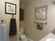 Cozy bathroom featuring a toilet, a framed flower print and framed toilet paper artwork at 12931 W Florida Dr, Lakewood, CO 80228