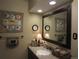 Charming bathroom with granite countertops, decorative wall art, and a large mirror over the sink at 12931 W Florida Dr, Lakewood, CO 80228