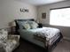 Comfortable bedroom with a cozy bed, accent chair, and plenty of natural light from the bright window at 12931 W Florida Dr, Lakewood, CO 80228