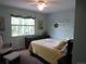 Inviting bedroom with soft blue walls, charming decor, and a comfortable reading corner at 12931 W Florida Dr, Lakewood, CO 80228