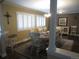 Elegant dining room with large windows, hardwood floors, and a classic chandelier above a round dining table at 12931 W Florida Dr, Lakewood, CO 80228