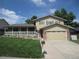 Charming two-story home with a well-manicured lawn, covered porch, and attached two-car garage at 12931 W Florida Dr, Lakewood, CO 80228