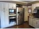 Modern kitchen featuring stainless steel appliances, sleek white cabinetry, and a built-in microwave and oven at 12931 W Florida Dr, Lakewood, CO 80228