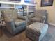 Comfortable seating area with two upholstered armchairs and a matching ottoman, perfect for relaxation at 12931 W Florida Dr, Lakewood, CO 80228