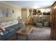Spacious living room with a cozy sofa, an elegant glass coffee table, and stairs leading to upper floors at 12931 W Florida Dr, Lakewood, CO 80228