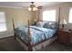 Bright bedroom features a four poster bed, side tables, and natural light from two windows at 12931 W Florida Dr, Lakewood, CO 80228