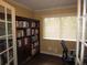 Bright office space with a bookshelf, a comfortable desk, and a window allowing for natural light at 12931 W Florida Dr, Lakewood, CO 80228