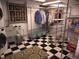 Functional storage and laundry area with shelving units, clothing racks, and a washer/dryer set at 12931 W Florida Dr, Lakewood, CO 80228