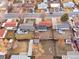 A bird's-eye view displaying a neighborhood where the home has a fenced-in back and front yard at 5116 Jellison St, Arvada, CO 80002