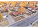 An aerial view featuring the home with a fenced yard and mature trees in a residential neighborhood at 5116 Jellison St, Arvada, CO 80002