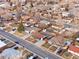 A high-angle view captures a residential area with well-spaced homes and tree-lined streets at 5116 Jellison St, Arvada, CO 80002
