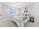 This well-lit bedroom features a plush carpet, comfortable queen bed, and neutral decor at 5116 Jellison St, Arvada, CO 80002