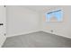 This bedroom offers plush carpet, a bright window and a spacious closet at 5116 Jellison St, Arvada, CO 80002