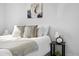 Close up of the bed showing stylish throw pillows and a bedside table with clock and decor at 5116 Jellison St, Arvada, CO 80002