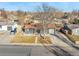 Aerial view of charming home with fenced yard, mature trees, and convenient driveway at 5116 Jellison St, Arvada, CO 80002